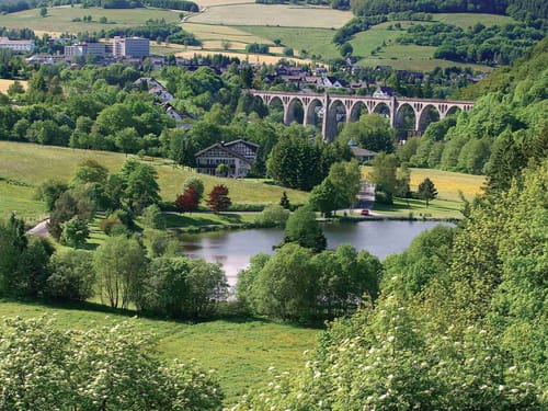 Idyllische Landschaft mit Viadukt und See im Grünen