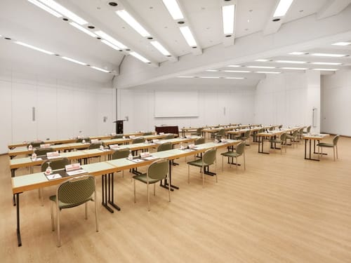 Großer Raum mit vielen Tischen und Stühlen
