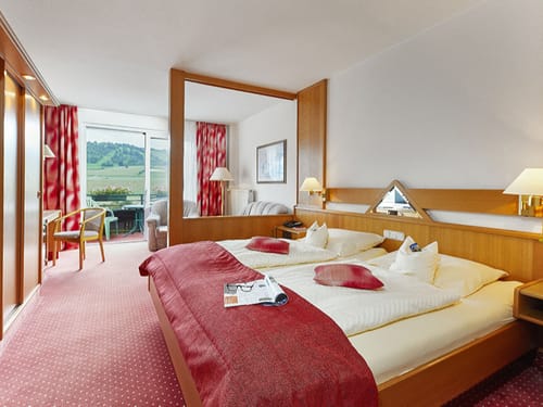 Doppelzimmer mit Doppelbett, Sofalounge und Schreibtisch