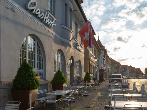 Hoteleingang mit verschiedenen Sitzgruppen vor dem Haus