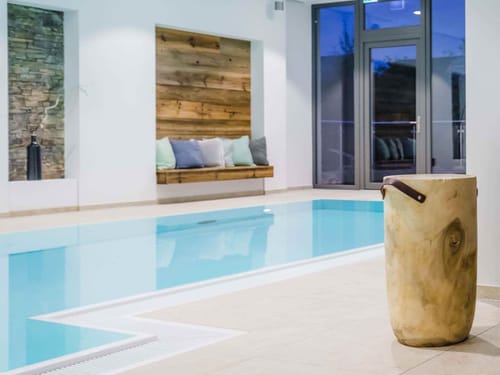 Moderner Innenpool mit Holz- und Steinakzenten