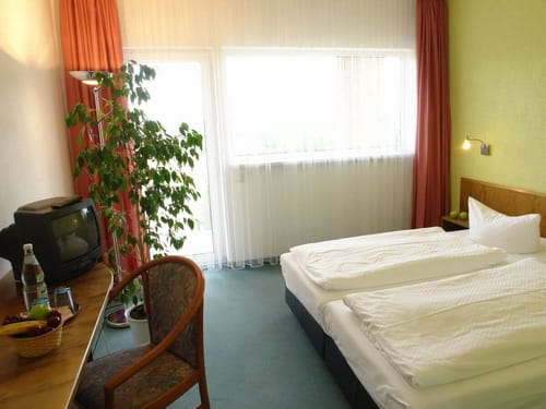 geräumiges Doppelzimmer mit TV, Schreibtisch und Sessel