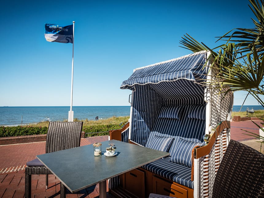 Maritimer Strandkorb auf der sonnigen Terrasse