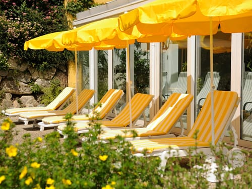 Hotelterrasse mit Relaxliegen und Sonnenschirmen