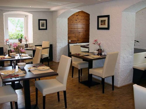 Frühstücksraum mit kleinen Tischen für zwei Personen