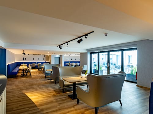 Speisesaal mit verschiedenen Tisch- und Loungegruppen