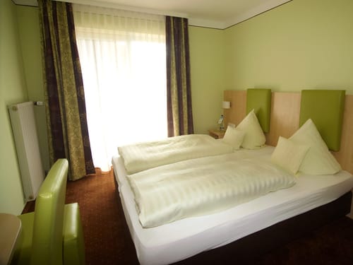 Kleines Hotelzimmer mit einem Stuhl und einem Schreibtisch