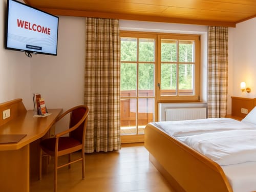 Komfortables Hotelzimmer mit Balkon und Waldblick