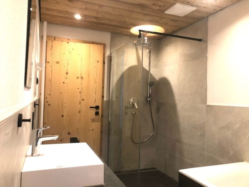 Modernes Badezimmer mit Holzdecke und offener Dusche