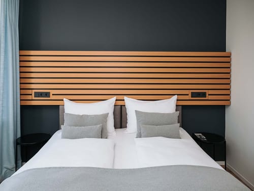 Modernes Hotelzimmer mit stilvollem Holzkopfteil