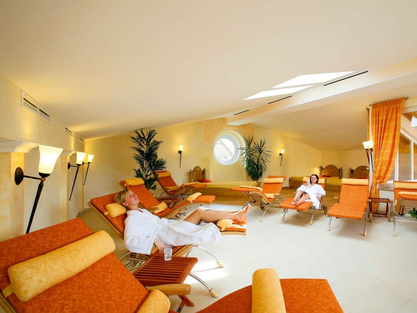 Entspannungsraum in einem Spa mit Liegestühlen und entspannenden Gästen