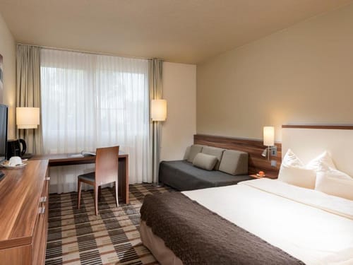 Komfortables Hotelzimmer mit Doppelbett und Sitzecke – modern eingerichtet