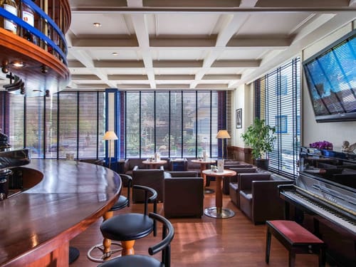 Die exklusive Bar-Lounge überzeugt mit elegantem Interieur, einem Yamaha-Klavier und stimmungsvoller Beleuchtung für unvergessliche Abende