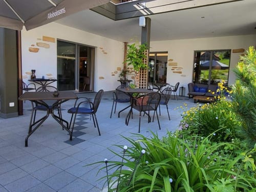 Gemütliche Außenterrasse des Restaurants Alloboissons mit Gartenmöbeln